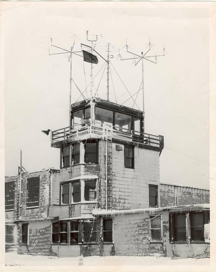 Early Canadian control tower with antenna masts, covered in ice - one of the first ATC towers in Canada